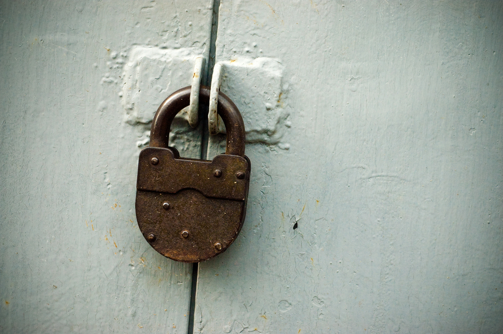 rusty lock on the grey gate