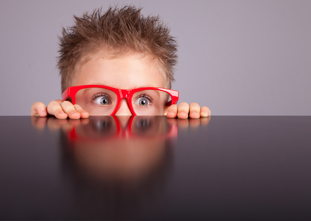 Boy looking over the top of a table